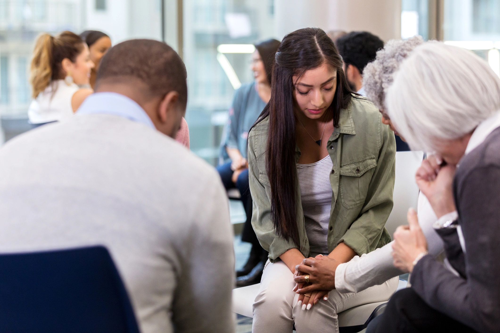 Small group praying together in a circle