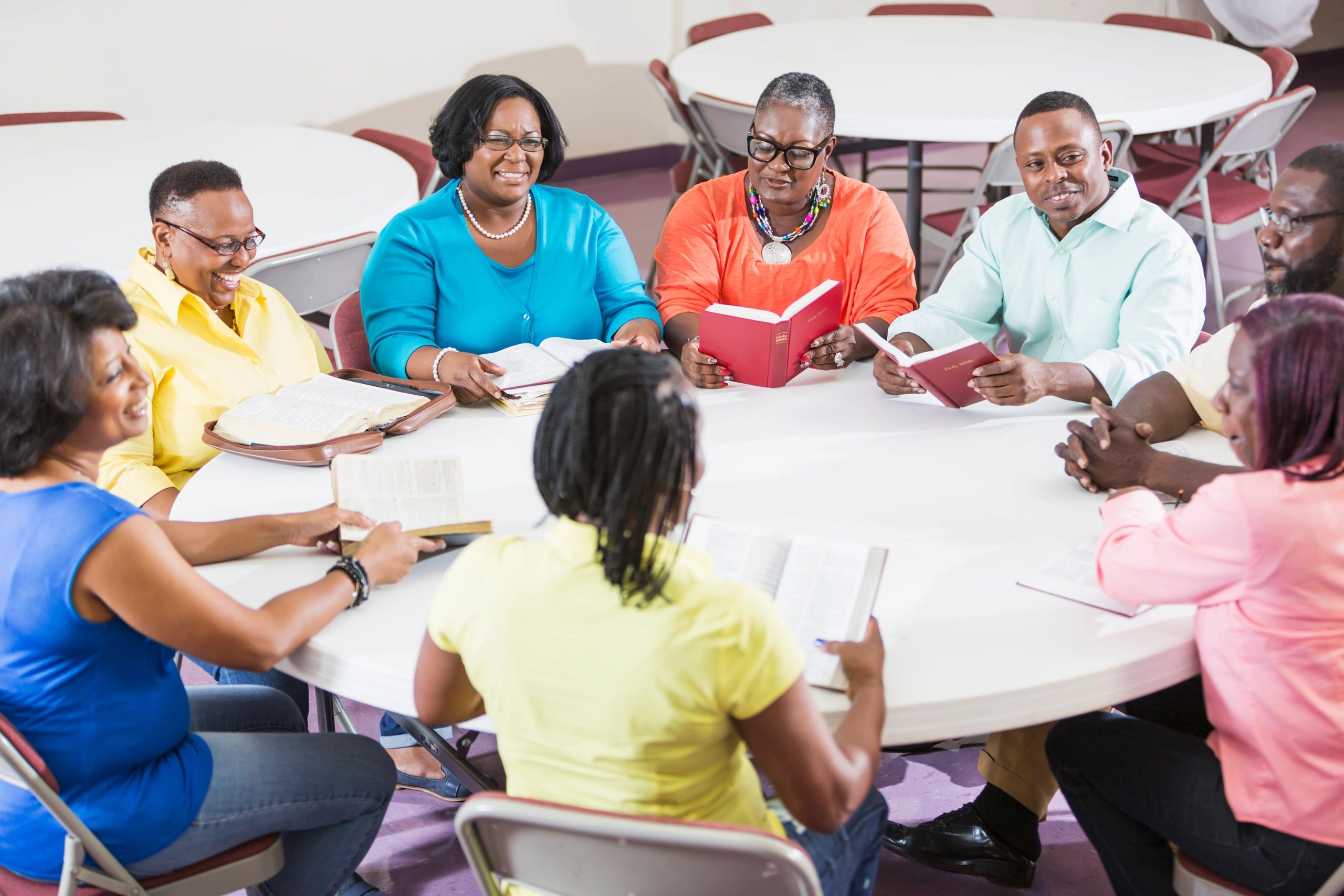 Adults gathered around a table for Bible study